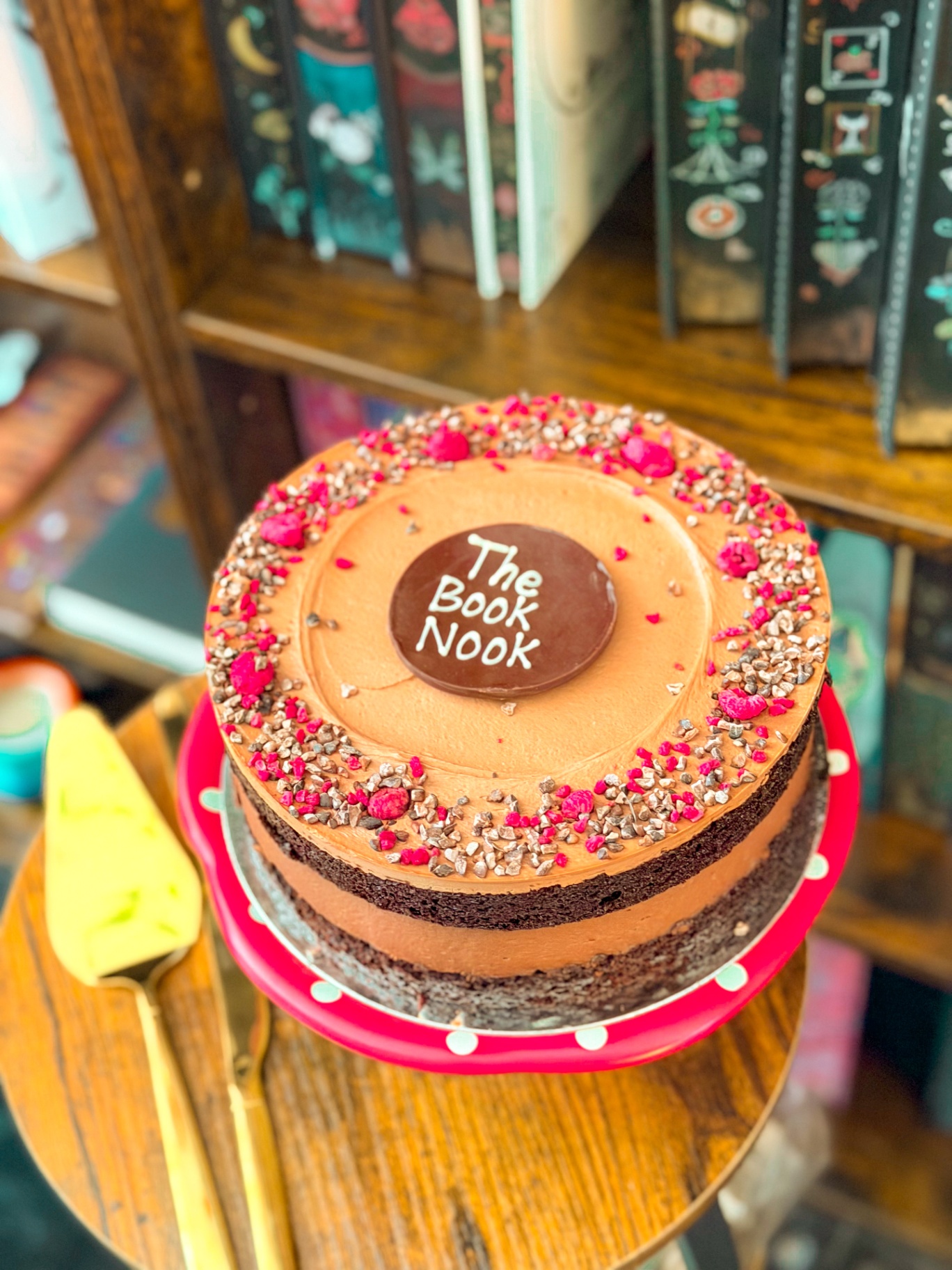 A chocolate cake decorated with The Book Nook logo