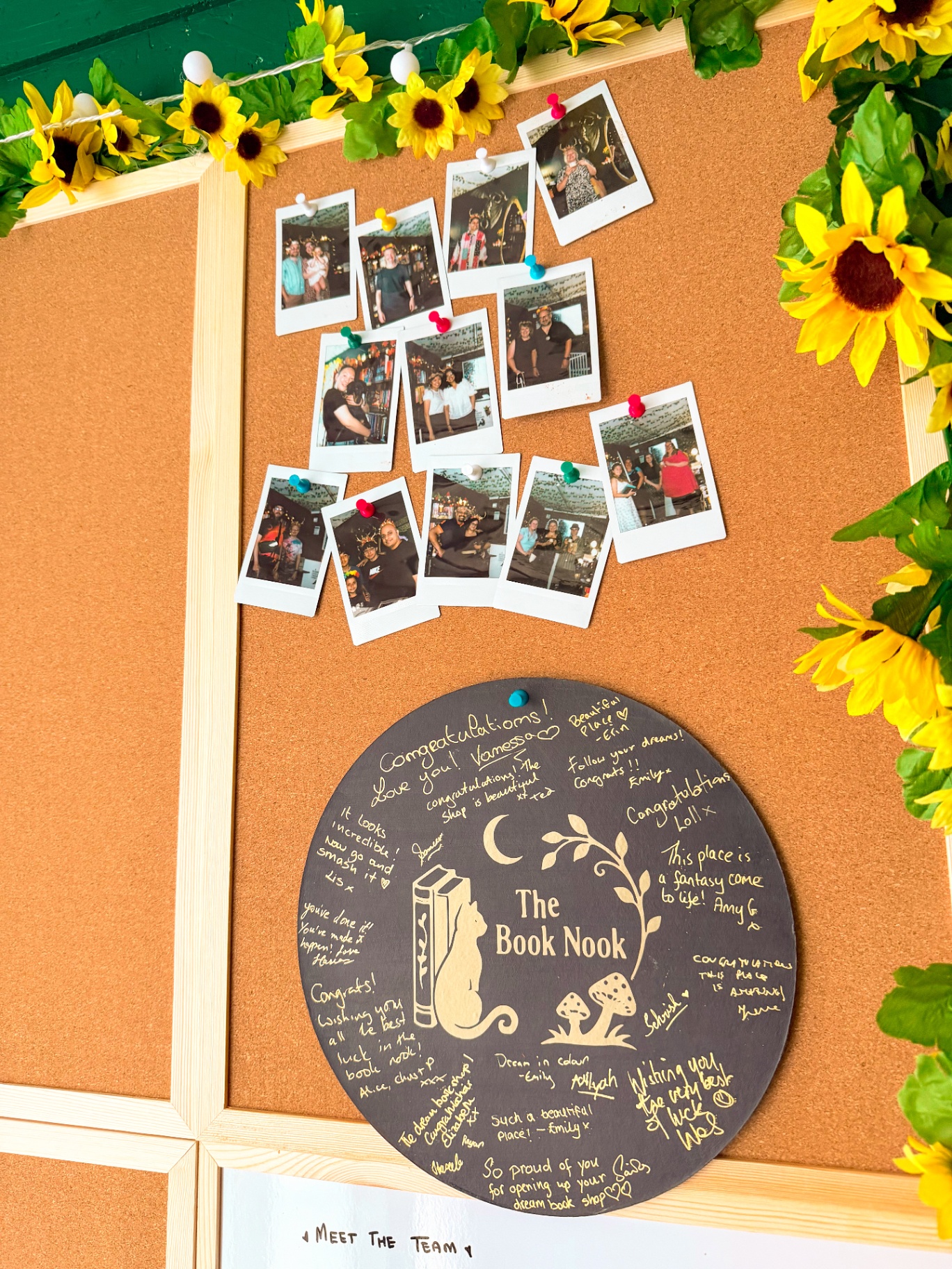 Signed opening day plaque and polaroids on the noticeboard