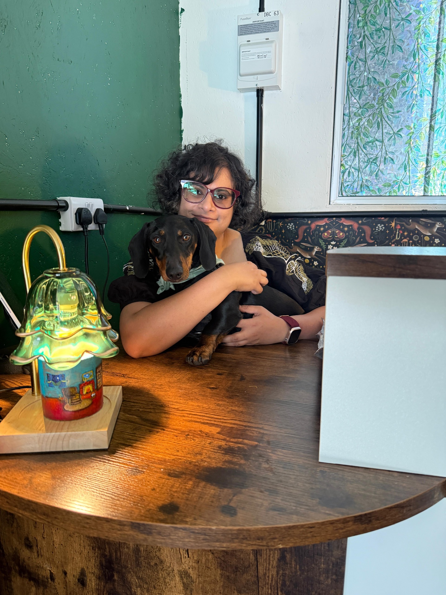 The owner and a dachshund at the counter
