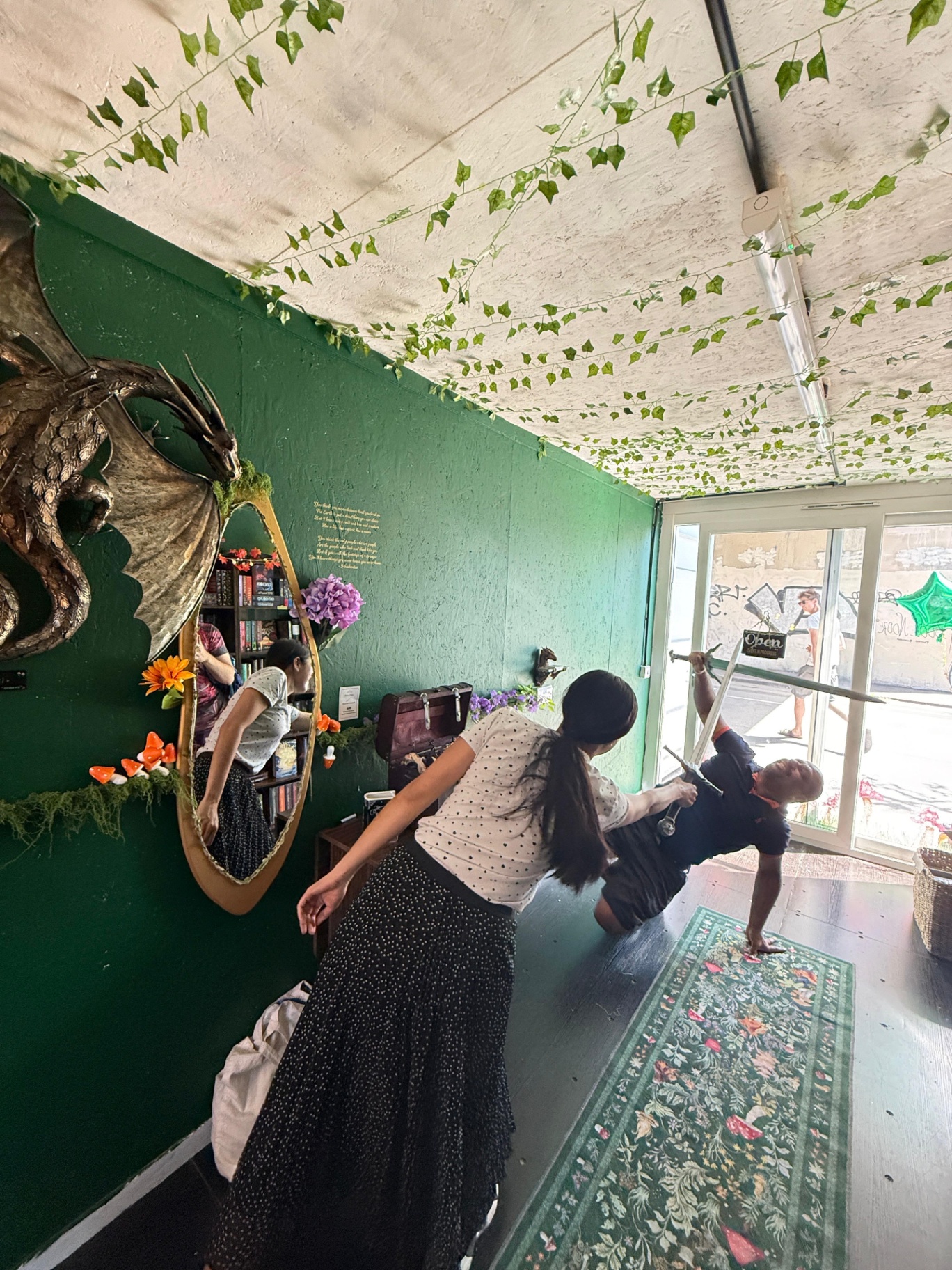 Guests exploring the shop with a sword prop